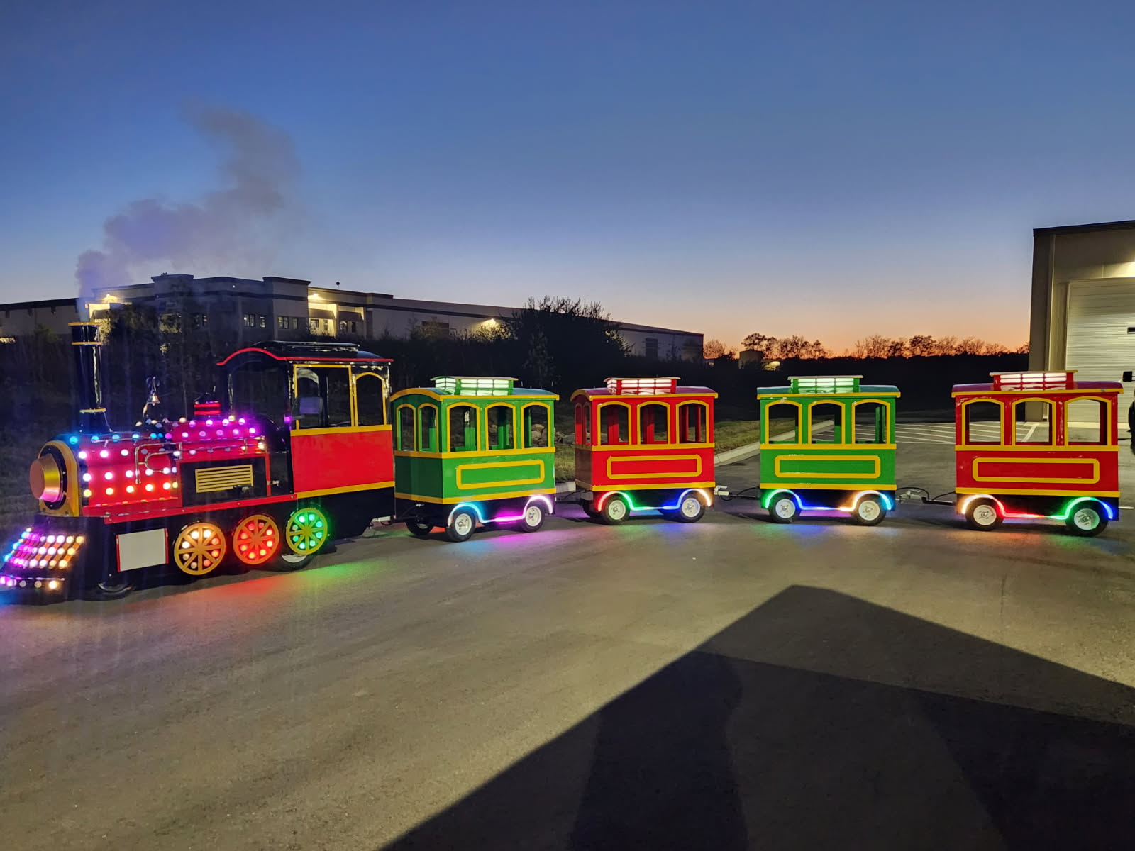 Trackless train with lights at a Kansas City evening event